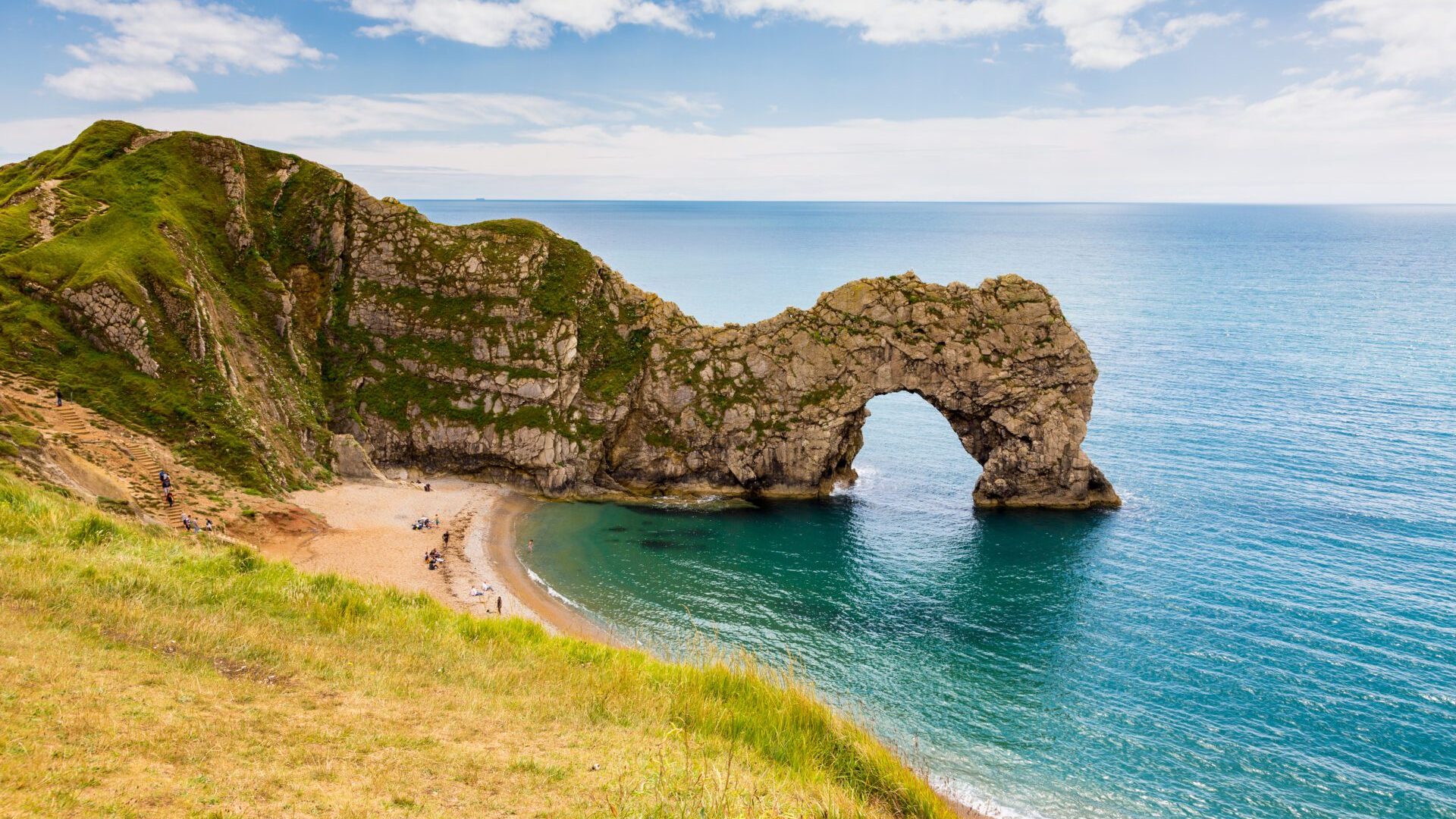 Durdle Door rock formation in the sea off a beautiful beach in Dorset