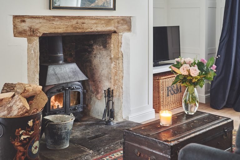 A log burner in a cosy cottage