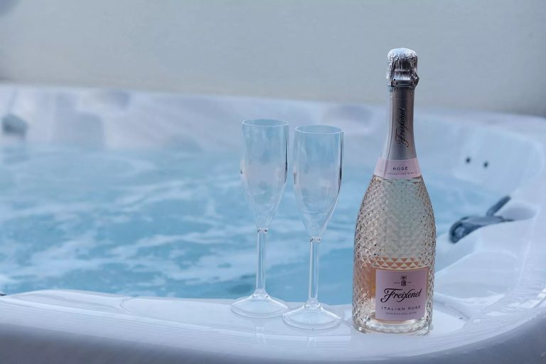 Rose and glasses on the side of the hot tub